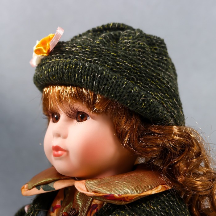 Кукла коллекционная керамика "Алёна в платье с цветами, в зелёной шапке и джемпере" 30 см